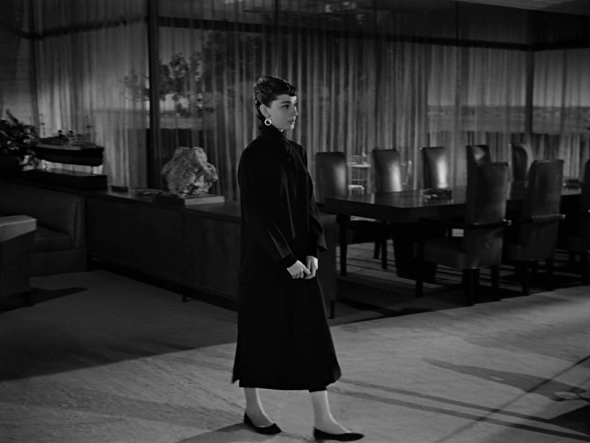 Sabrina is Audrey Hepburn's first collaboration with Givenchy. In this picture, she wears a black coat that matched the Parisienne standards of Audrey Hepburn's style.
