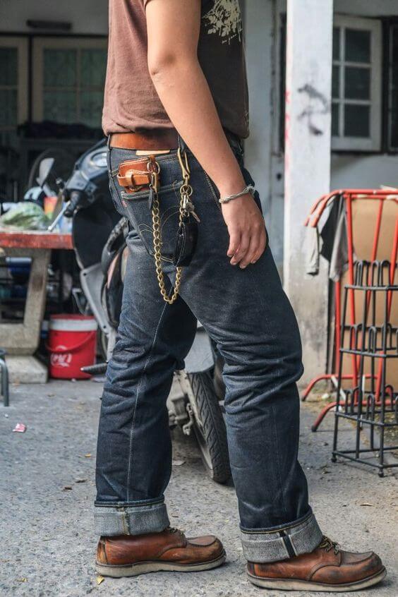 A man wearing a pair of Samurai Jeans with a chain and pair of brown boots: Featured image